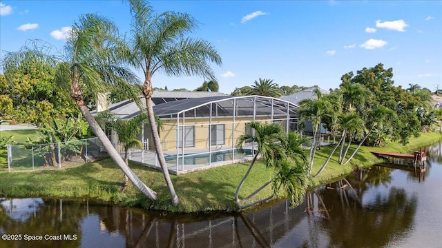 990 Harbor Pines Dr, Merritt Island, FL 32952 - rear view of property featuring a water view, an outdoor pool, and a lanai