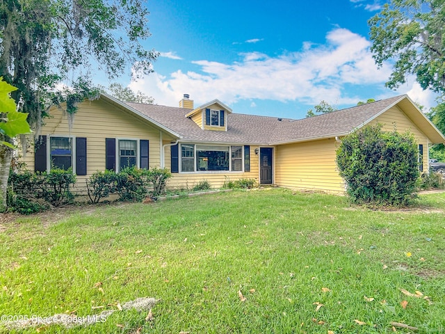 750 SW 91st Pl, Ocala, FL 34476 - view of front of property featuring a front yard, a chimney, and a shingled roof