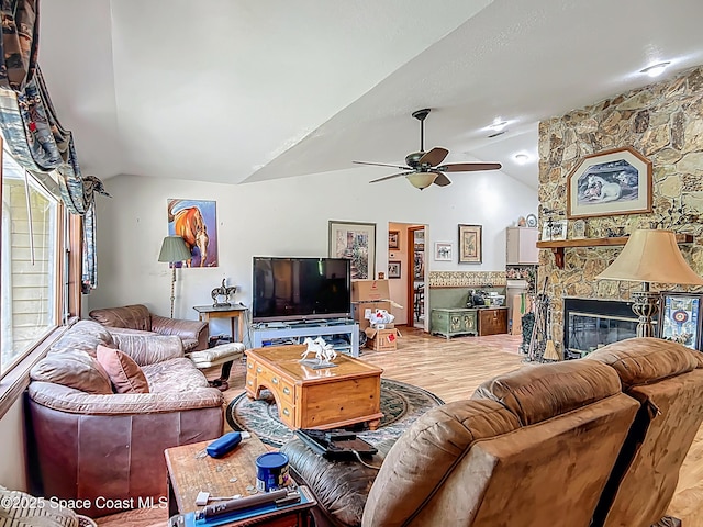 750 SW 91st Pl, Ocala, FL 34476 - living area featuring vaulted ceiling, ceiling fan, wood finished floors, a fireplace, and healthy amount of natural light