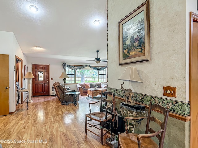 750 SW 91st Pl, Ocala, FL 34476 - living area with a textured wall, light wood-style floors, and a ceiling fan
