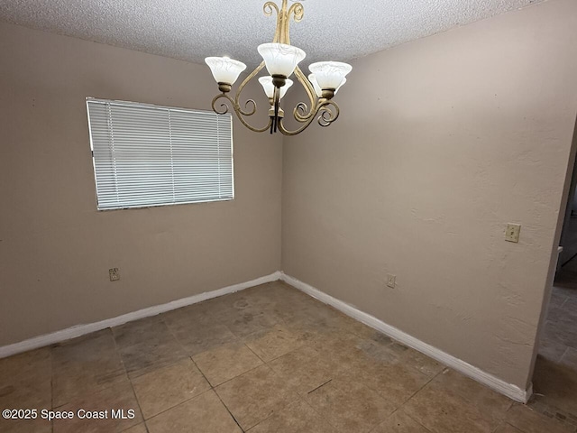 600 Byron Ave, Daytona Beach, FL 32114 - unfurnished room featuring a chandelier, a textured ceiling, baseboards, and tile patterned floors