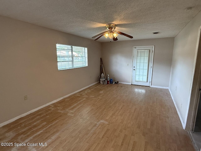 600 Byron Ave, Daytona Beach, FL 32114 - spare room with light wood-style floors, baseboards, a ceiling fan, and a textured ceiling