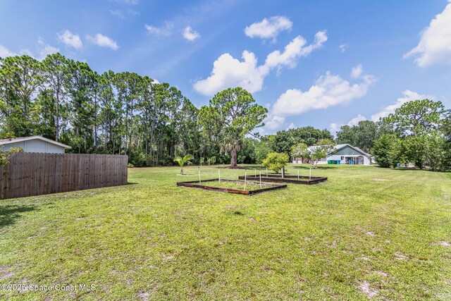 4027 Secretariat Ln, Malabar, FL 32950 - view of yard featuring a vegetable garden and view of scattered trees