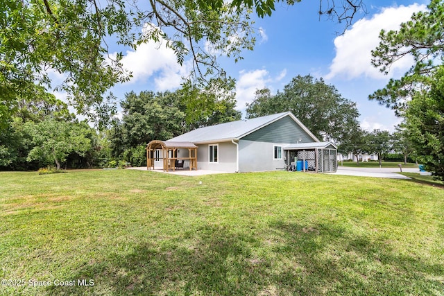 4027 Secretariat Ln, Malabar, FL 32950 - back of property featuring a lawn, metal roof, and stucco siding