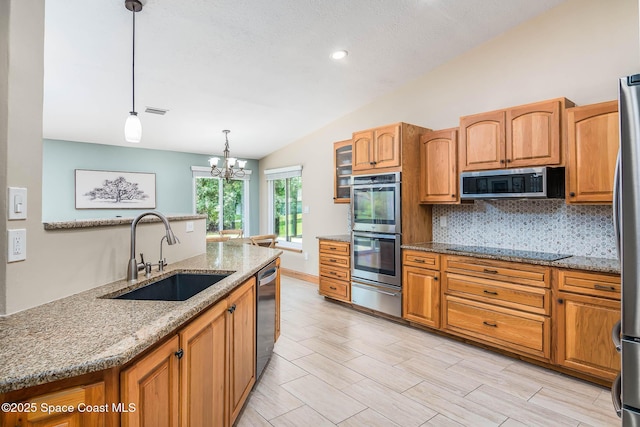 4027 Secretariat Ln, Malabar, FL 32950 - kitchen featuring a sink, stainless steel appliances, a warming drawer, vaulted ceiling, and light stone countertops