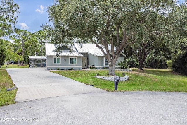 4027 Secretariat Ln, Malabar, FL 32950 - view of front of home featuring concrete driveway, a front lawn, and a carport