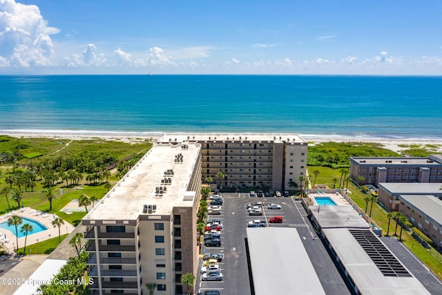 3170 N Atlantic Ave Unit 407, Cocoa Beach, FL 32931 - drone / aerial view of expansive beach, apartment complex / building, and a pool area