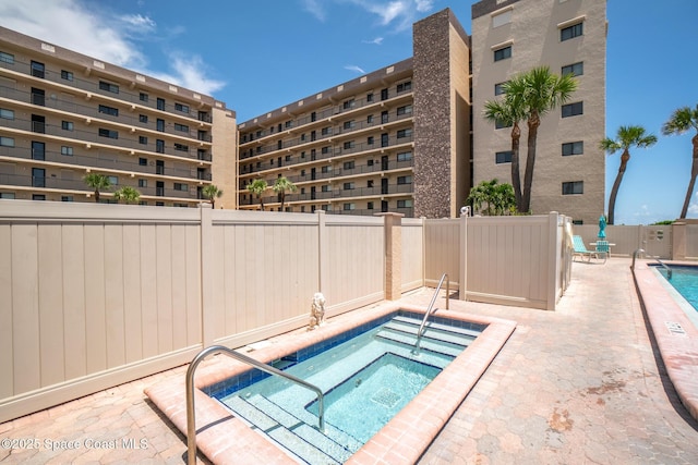3170 N Atlantic Ave Unit 407, Cocoa Beach, FL 32931 - community pool with a hot tub, a fenced backyard, and a patio area