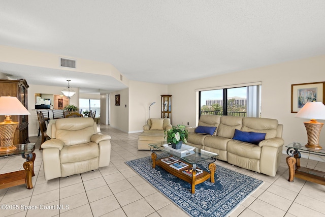 3170 N Atlantic Ave Unit 407, Cocoa Beach, FL 32931 - living room featuring light tile patterned floors and plenty of natural light