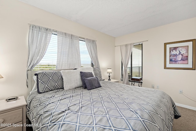 3170 N Atlantic Ave Unit 407, Cocoa Beach, FL 32931 - bedroom with carpet flooring, baseboards, and a textured ceiling