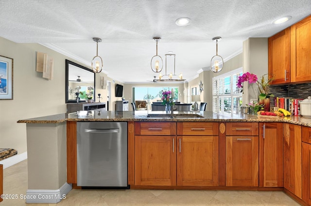 211 S 24th St Unit 202, Cocoa Beach, FL 32931 - kitchen with ornamental molding, brown cabinets, dark stone counters, pendant lighting, and a textured ceiling