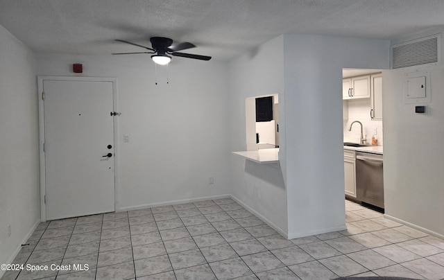 230 Columbia Dr Unit 213, Cape Canaveral, FL 32920 - unfurnished room featuring a sink, light tile patterned floors, ceiling fan, a textured ceiling, and baseboards