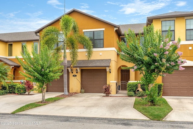 1415 Lara Cir Unit 105, Rockledge, FL 32955 - townhome / multi-family property featuring stucco siding, driveway, and an attached garage