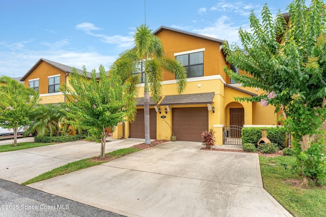 1415 Lara Cir Unit 105, Rockledge, FL 32955 - view of property with stucco siding, concrete driveway, and a garage