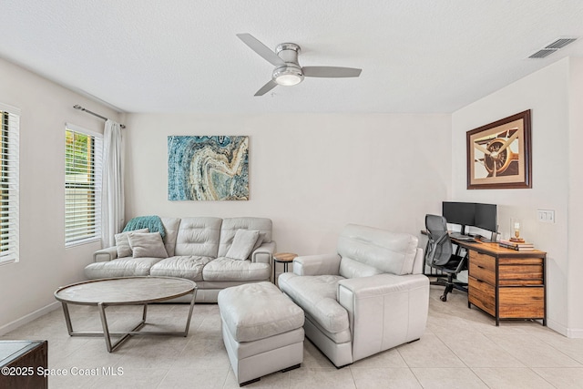 1415 Lara Cir Unit 105, Rockledge, FL 32955 - living room with a ceiling fan, light tile patterned floors, an office area, baseboards, and a textured ceiling