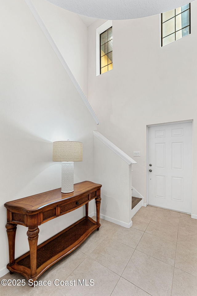 1415 Lara Cir Unit 105, Rockledge, FL 32955 - tiled foyer with stairway, a high ceiling, and baseboards