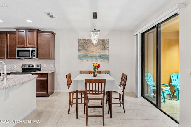 1415 Lara Cir Unit 105, Rockledge, FL 32955 - dining space with light tile patterned floors, recessed lighting, and baseboards