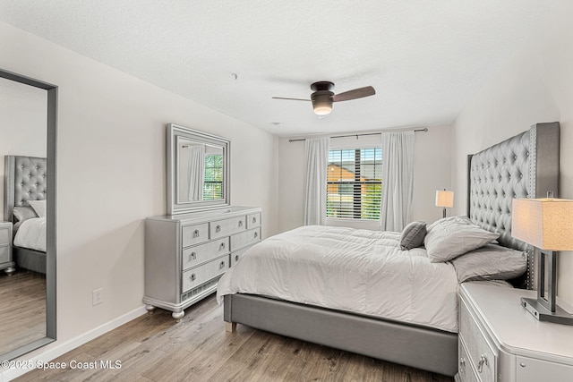 1415 Lara Cir Unit 105, Rockledge, FL 32955 - bedroom with light wood finished floors, baseboards, ceiling fan, and a textured ceiling