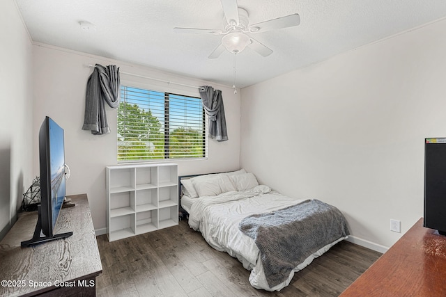 1415 Lara Cir Unit 105, Rockledge, FL 32955 - bedroom with wood finished floors, ceiling fan, baseboards, and a textured ceiling