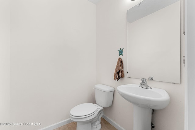 1415 Lara Cir Unit 105, Rockledge, FL 32955 - bathroom featuring baseboards, toilet, and tile patterned floors
