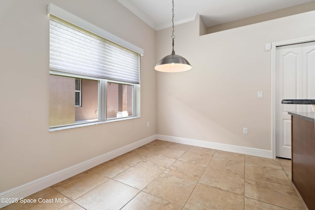3140 Constellation Dr, Melbourne, FL 32940 - unfurnished dining area featuring baseboards, light tile patterned flooring, and crown molding
