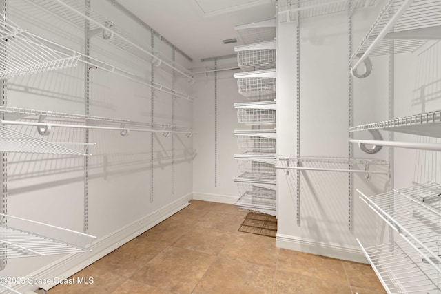 3140 Constellation Dr, Melbourne, FL 32940 - walk in closet featuring tile patterned flooring