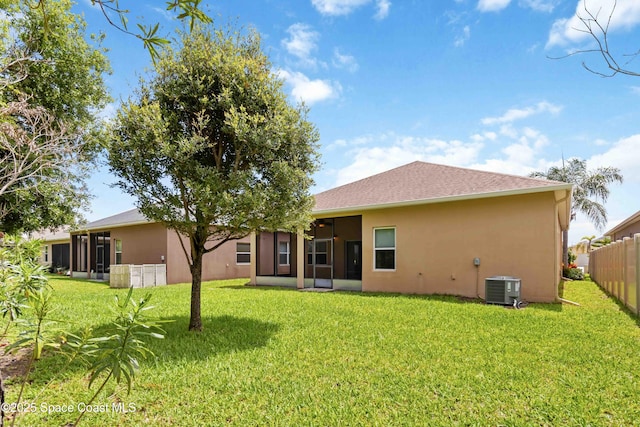 3140 Constellation Dr, Melbourne, FL 32940 - back of house featuring a sunroom, central AC, and stucco siding