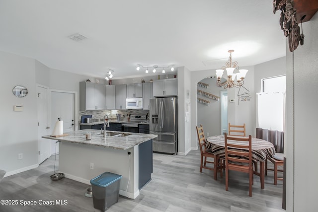 4345 Millicent Cir, Melbourne, FL 32901 - kitchen featuring stainless steel appliances, a sink, backsplash, a chandelier, and gray cabinets