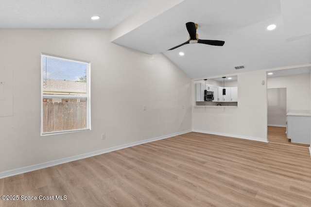 2295 Wood St, Melbourne, FL 32904 - unfurnished living room featuring lofted ceiling, light wood-style floors, baseboards, a ceiling fan, and recessed lighting