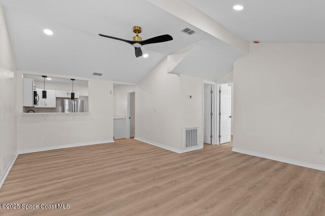 2295 Wood St, Melbourne, FL 32904 - unfurnished living room with ceiling fan, vaulted ceiling, baseboards, light wood-style floors, and recessed lighting