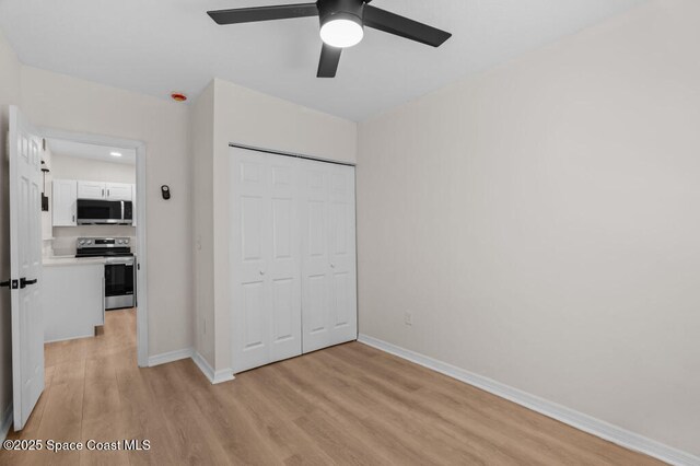 2295 Wood St, Melbourne, FL 32904 - unfurnished bedroom with light wood-type flooring, baseboards, a closet, and ceiling fan