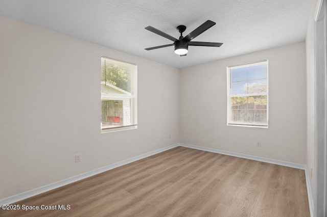 2295 Wood St, Melbourne, FL 32904 - unfurnished room with light wood-type flooring, baseboards, a textured ceiling, and a ceiling fan