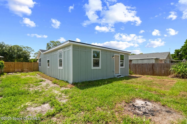 2295 Wood St, Melbourne, FL 32904 - rear view of property featuring board and batten siding