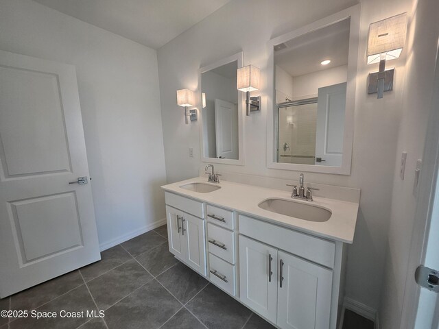 215 Ocarina St SW Unit 31, Palm Bay, FL 32908 - full bathroom with double vanity, a shower with shower door, tile patterned floors, and baseboards