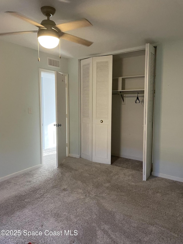115 E Colonial Ct Unit C, Indian Harbour Beach, FL 32937 - unfurnished bedroom featuring a closet, carpet floors, and a ceiling fan