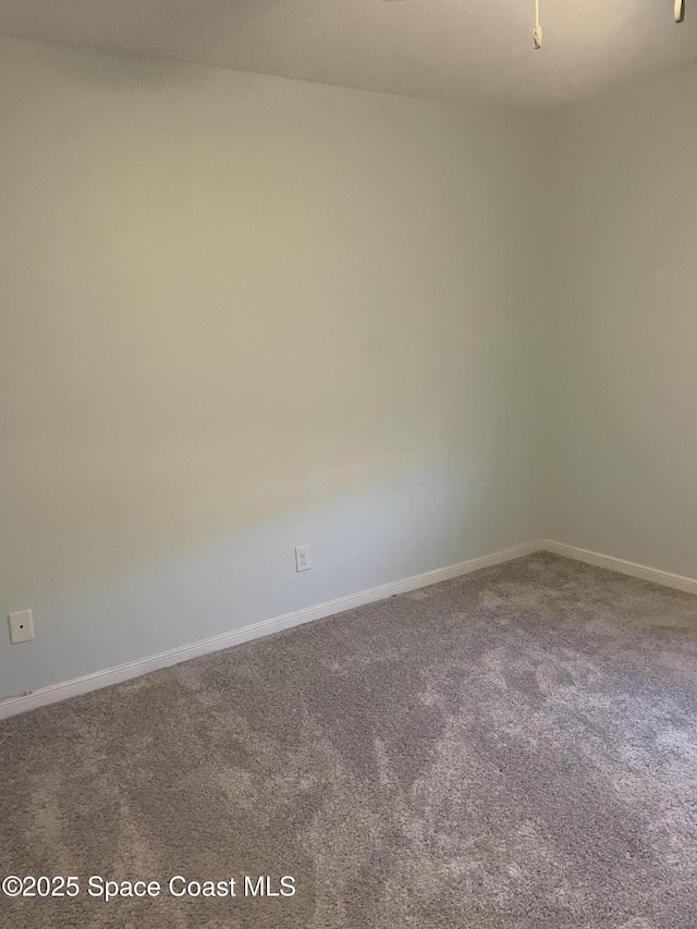 115 E Colonial Ct Unit C, Indian Harbour Beach, FL 32937 - carpeted spare room with baseboards