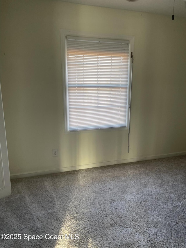 115 E Colonial Ct Unit C, Indian Harbour Beach, FL 32937 - carpeted empty room featuring baseboards