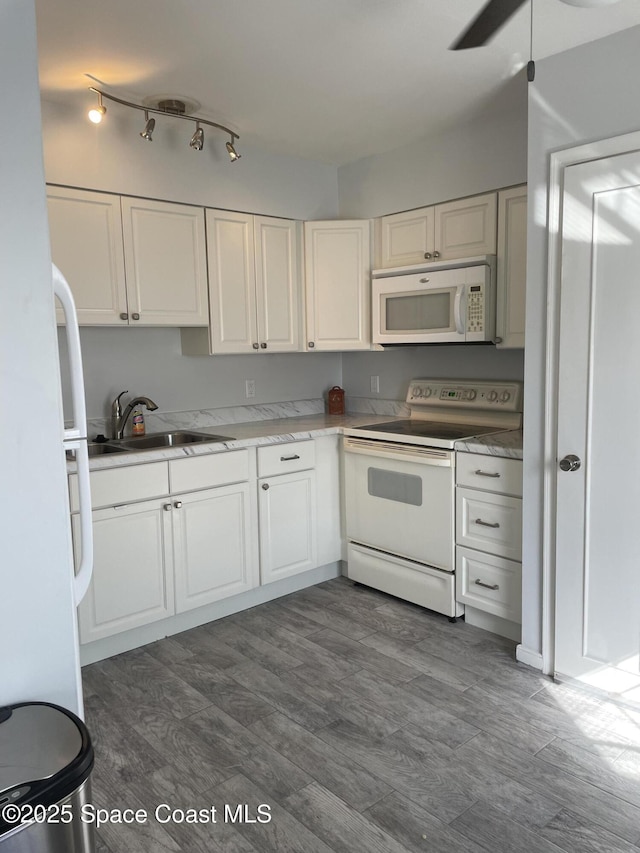 115 E Colonial Ct Unit C, Indian Harbour Beach, FL 32937 - kitchen with white appliances, a sink, ceiling fan, dark wood-type flooring, and white cabinetry