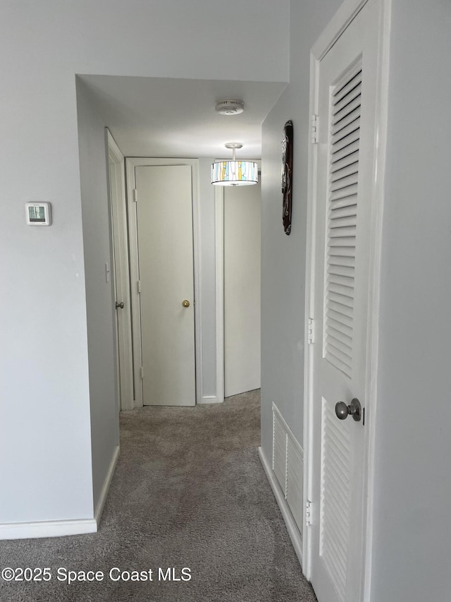 115 E Colonial Ct Unit C, Indian Harbour Beach, FL 32937 - hallway featuring carpet flooring and baseboards