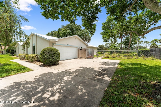 740 Hunan St NE, Palm Bay, FL 32907 - view of property exterior with stucco siding, driveway, and an attached garage