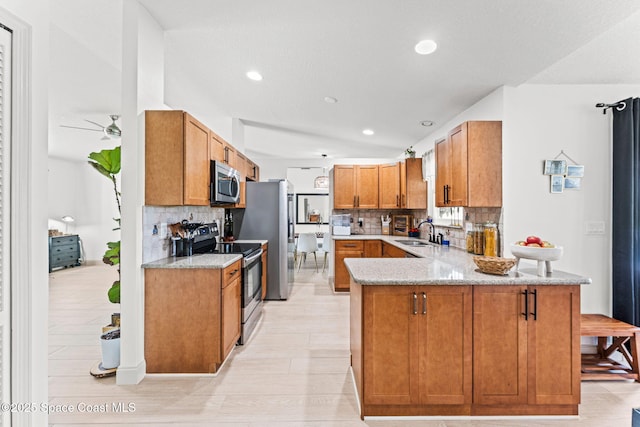 740 Hunan St NE, Palm Bay, FL 32907 - kitchen with appliances with stainless steel finishes, a peninsula, tasteful backsplash, light stone counters, and recessed lighting