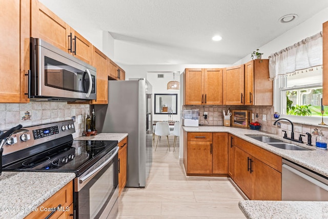 740 Hunan St NE, Palm Bay, FL 32907 - kitchen featuring stainless steel appliances, tasteful backsplash, brown cabinets, and recessed lighting