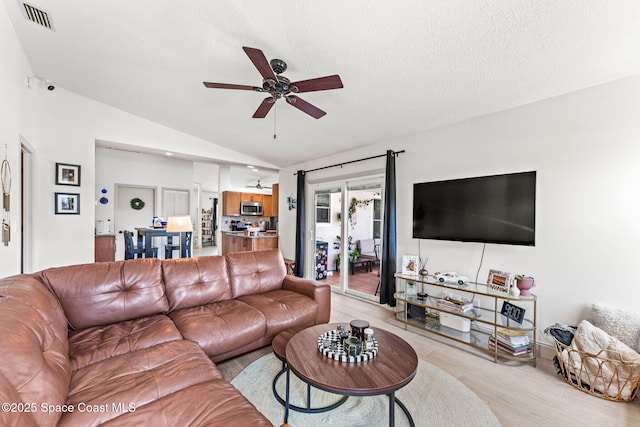 740 Hunan St NE, Palm Bay, FL 32907 - living area with a ceiling fan, lofted ceiling, and light wood finished floors