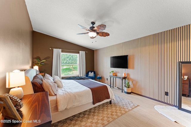 740 Hunan St NE, Palm Bay, FL 32907 - bedroom featuring wood finished floors, lofted ceiling, a textured ceiling, and a ceiling fan