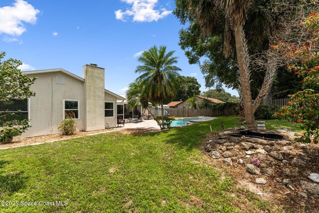 740 Hunan St NE, Palm Bay, FL 32907 - fenced backyard featuring a patio