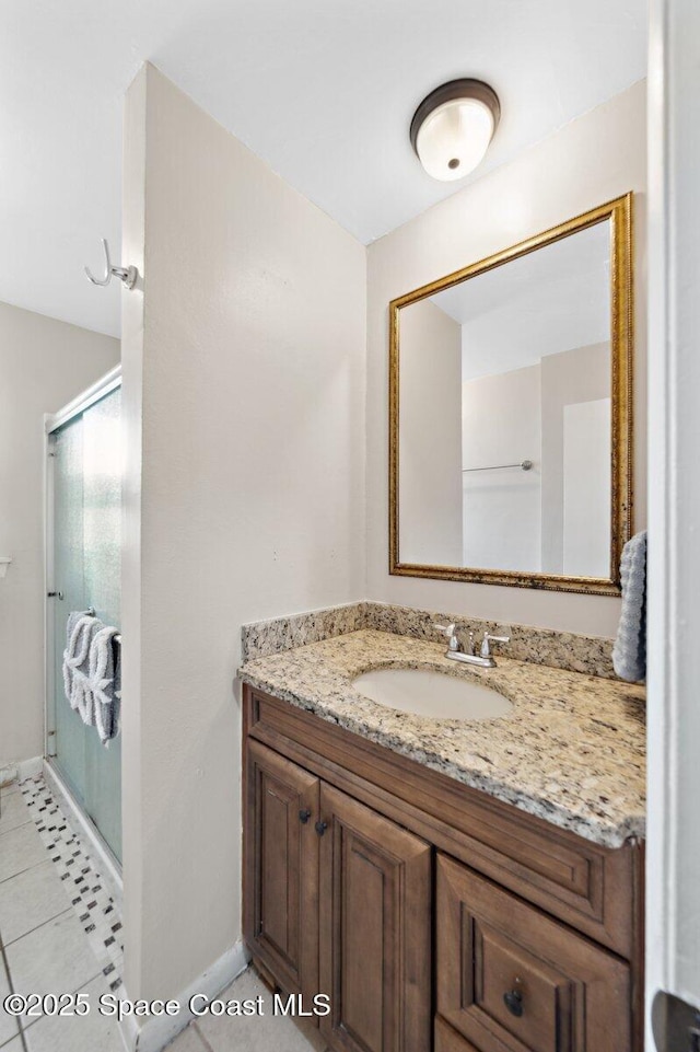 926 Caligula Ave SE, Palm Bay, FL 32909 - full bathroom with vanity, a shower stall, baseboards, and tile patterned floors