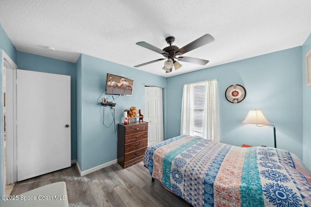 926 Caligula Ave SE, Palm Bay, FL 32909 - bedroom with wood finished floors, baseboards, a textured ceiling, a closet, and ceiling fan