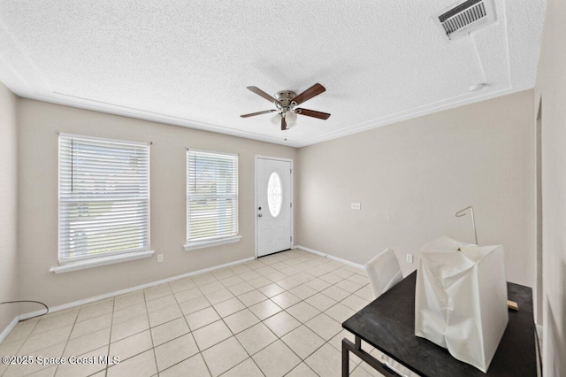 926 Caligula Ave SE, Palm Bay, FL 32909 - foyer entrance with a ceiling fan, a textured ceiling, baseboards, and light tile patterned floors