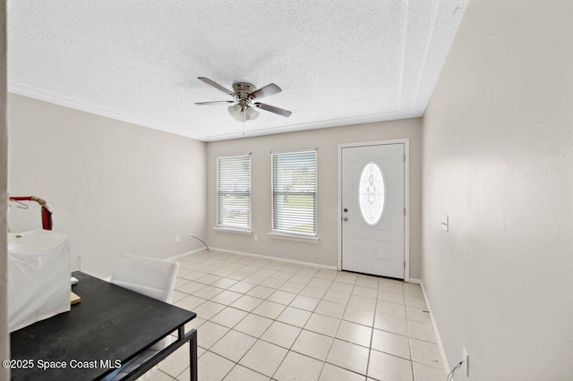 926 Caligula Ave SE, Palm Bay, FL 32909 - entrance foyer with ceiling fan, a textured ceiling, light tile patterned flooring, and baseboards