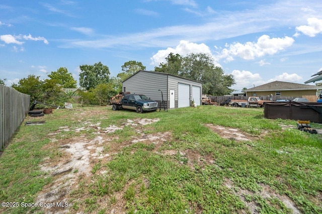 926 Caligula Ave SE, Palm Bay, FL 32909 - view of yard featuring a detached garage, an outdoor structure, and a hot tub